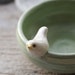 Sweet Little White Bird on a Tiny Light Green Bowl