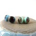 dark brown on blue studs and pale brown on pastel green studs