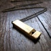 whistle statement necklace in brass on long minimal chain