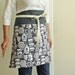 Kitchen goods on charcoal gray reversible half apron