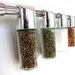 Featured in REAL SIMPLE March 2011. Totemspice chrome spice rack with everyday spices. Perfect gift for newlyweds and new homeowners.