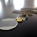 vintage optical lens necklace with locket and pale aquamarine
