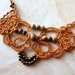 Necklace tatted in deep gold cotton with jasper beads