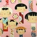 Yui Kokeshi Doll Fabric on Pink - By the Yard