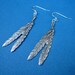 silver claw and feather earrings