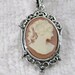 Charming Cameo Pendant . antique silver plated setting . carnelian & cream