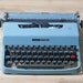 teal Olivetti Lettera 32 typewriter with case