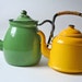 two vintage enamelware tea kettle in yellow and light green