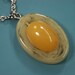 Silvercolor one-of-a-kind metal chain necklace with swirled creame light yellow and clear yellow bakelite plastic pendant