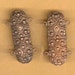 pair of fancy brass connectors, two loops on each side