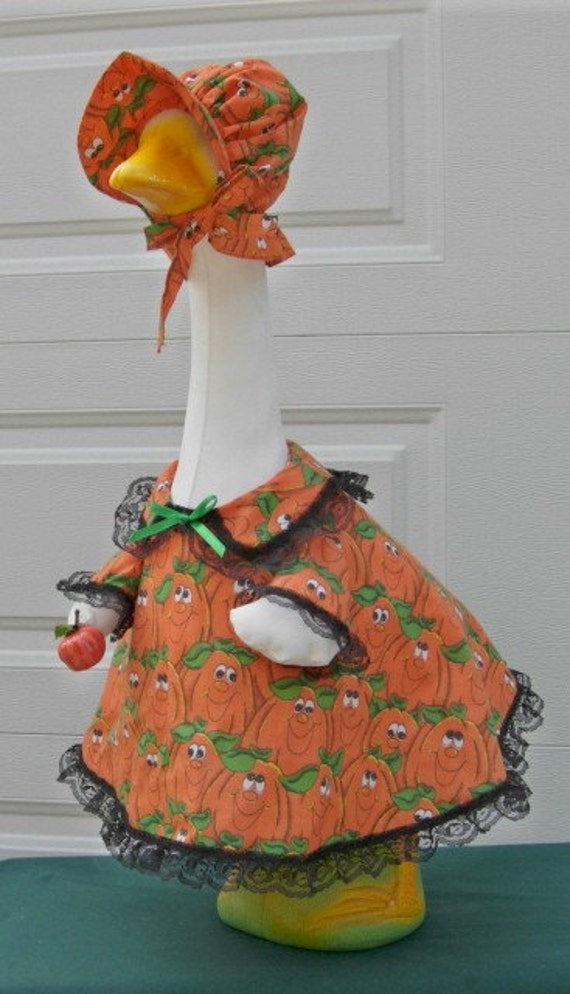 Cement goose outfit in happy face pumpkins for large geese