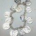 Charm bracelet with silver Roman faux coins