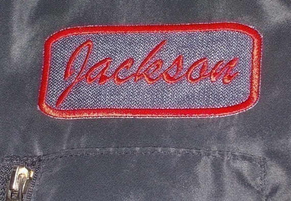 Denim Name Patch rectangle with red embroidery stitching.