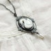 Swan lake - mother of pearl cut swan cameo on a blackened brass floral filigree and freshwater pearl necklace