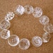 12 Vintage glass buttons, beads, transparent clear glass, assorted shapes and ornaments,