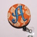 Many fabrics to design YOUR Badge Reel. Monogrammed single letter, Orange damask