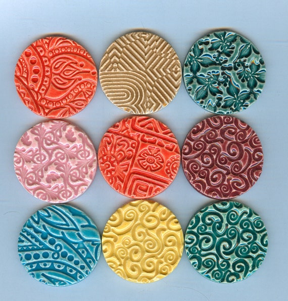 9 embossed round ceramic clay tiles...kiln fired