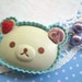 White Bear chocolate with strawberry and pink whipped cream topping