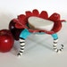 whimsical ceramic dish w/ curly striped legs