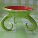 whimsical red & green dish with curly legs