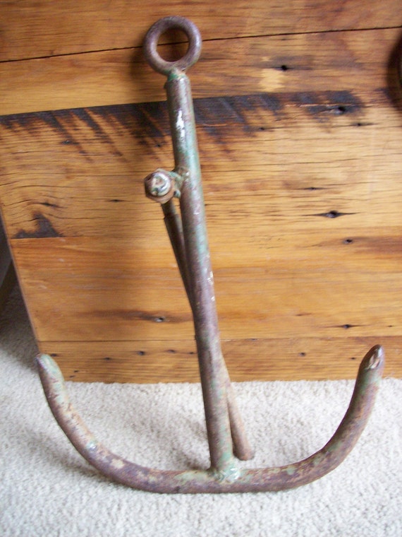 antique old green paint heavy boat anchor