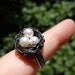 White Pearl Magic birdnest ring on silver floral adjustable band