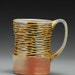 Ripple Mug with amber glaze, hand carved texture, wood and soda fired, porcelain