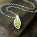 Tiny green leaf necklace in silver and concrete