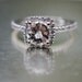 Sparkling brilliant sapphire in a 14k white gold cushion diamond setting