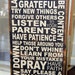 primitive looking (Family Rules Subway Art w/ custom family name) black with cream vinyl lettering pine wood sign
