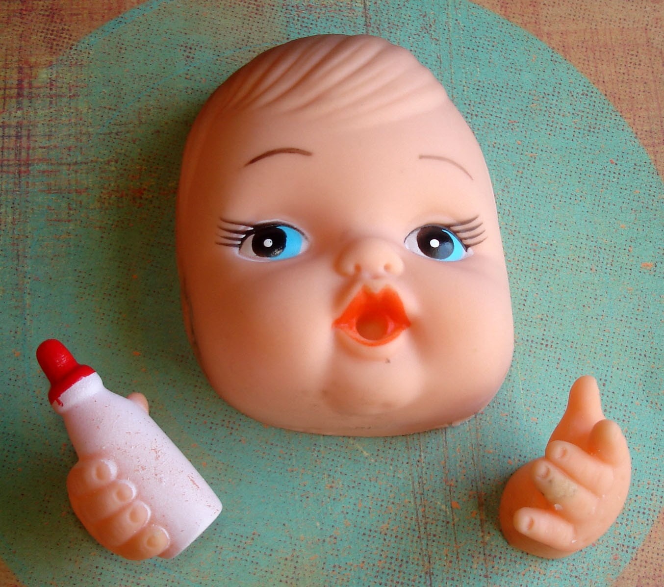 Set of Vintage Doll Face with Hands Holding Baby Bottle.