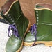 green rubber boots with yellow laces