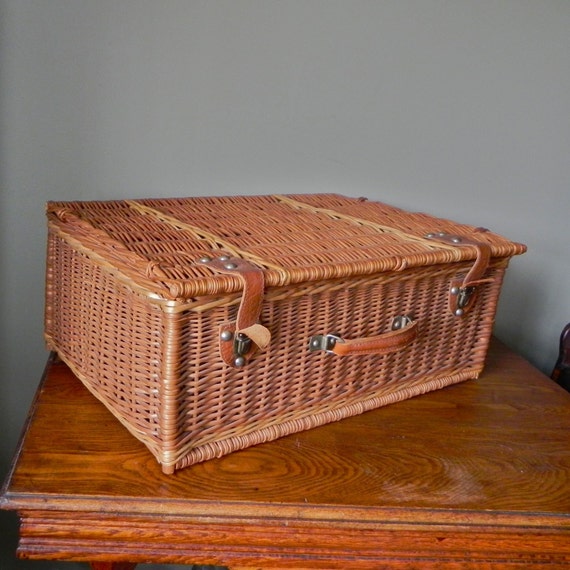 Vintage wicker suitcase with leather handle and clasps