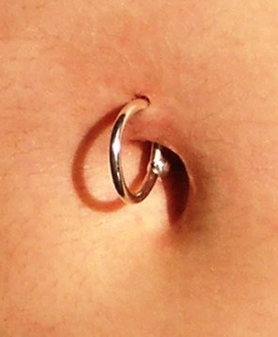 Silver belly button piercing