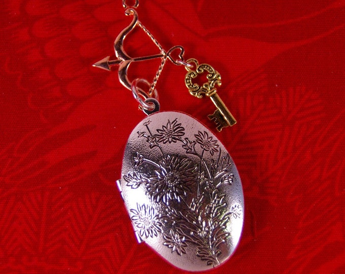 Elongated Floral Decorated Silver-tone Locket with Archery and Key Charms