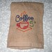 Crochet Hanging Towel embroidered with five cent coffee and a tan crochet top
