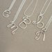 r e s e r v e d ....... for LAURAWALICKI. initial. letter. yours. sterling silver NECKLACE.