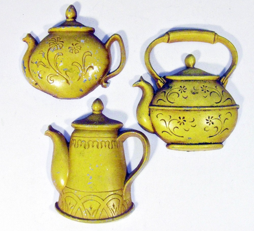 vintage wall decoration cast metal teapots by Sexton set