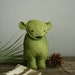 yves. a small green bear.