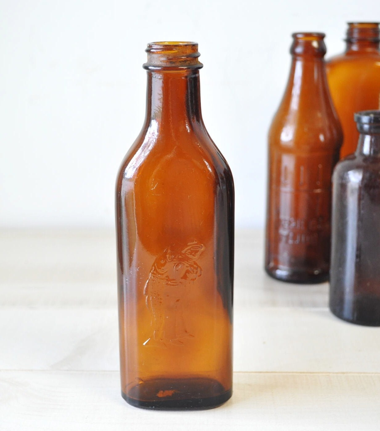 Vintage Amber Colored Glass Bottlefisherman with fish