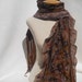 Nuno felt scarf in taupe, brown, gold and black.