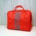 red weekend bag with turquoise wood grain