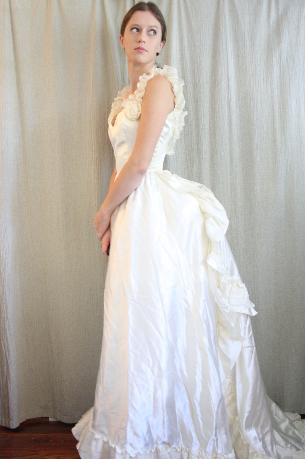 An image of a wedding dress with an over bustle.