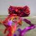 bird of paradise fiber effects . ribbon yarn bundle 12yds . red orange purple