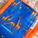 Baby burp cloth - Ed Emberley giraffes on bright orange hand dyed burp cloth