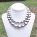 Neulla - Chunky, Graduated Double Strand Metallic Burnished Silver Beaded Necklace