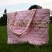 The AMY Reversible Tote Bag with Quilted Solid Pink outer and playful cat fabric lining with Decorative stripe on Exterior
