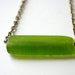 olivia necklace. moss green frosted glass tube on antique bronze chain.