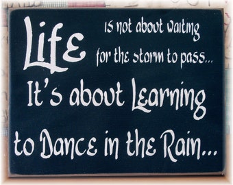 Life is not about waiting for the storm to pass it's about learning to dance in the rain sign