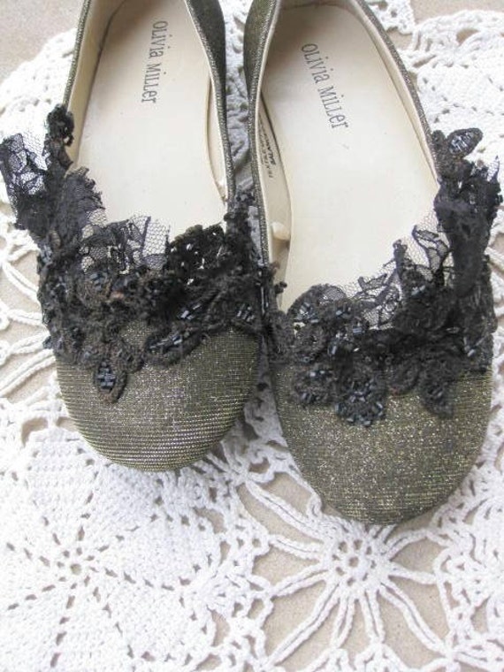 black flats with gold trim